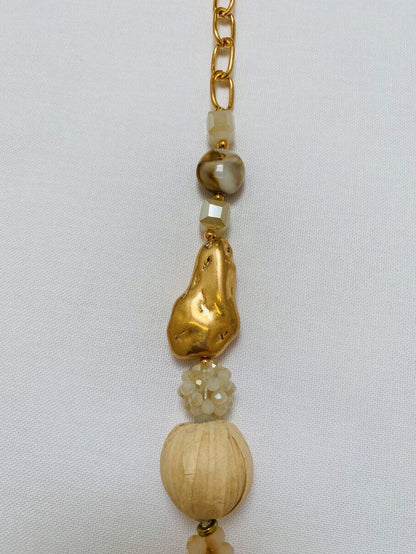 Lange goldene Halskette mit beigefarbenen Anhängern
